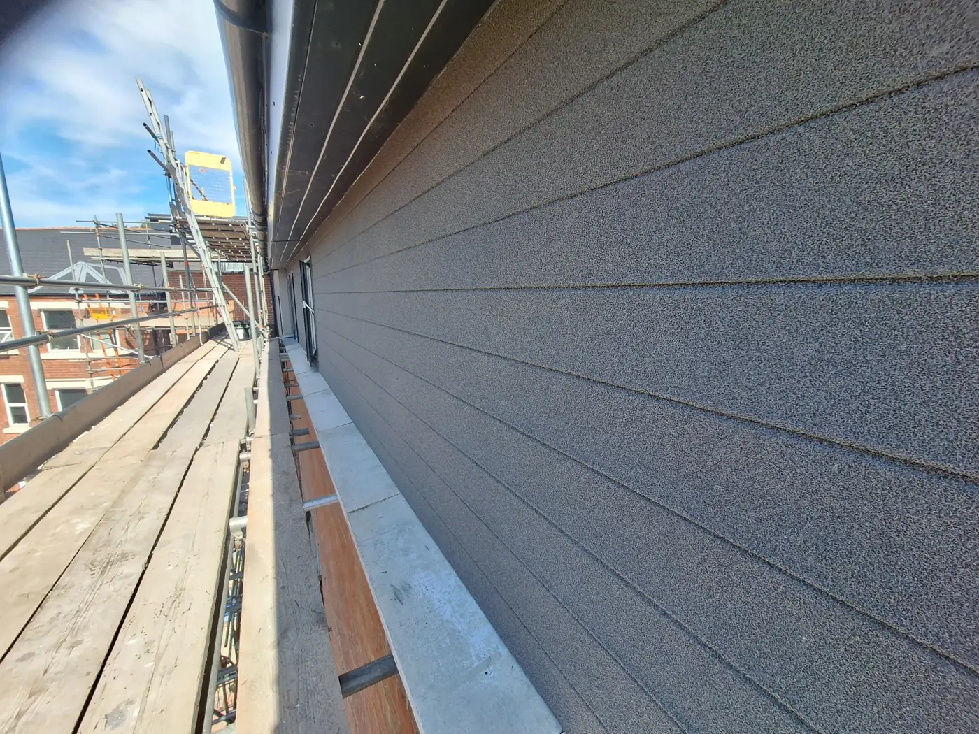 Close-up of finished grey cork texture on cladding boards