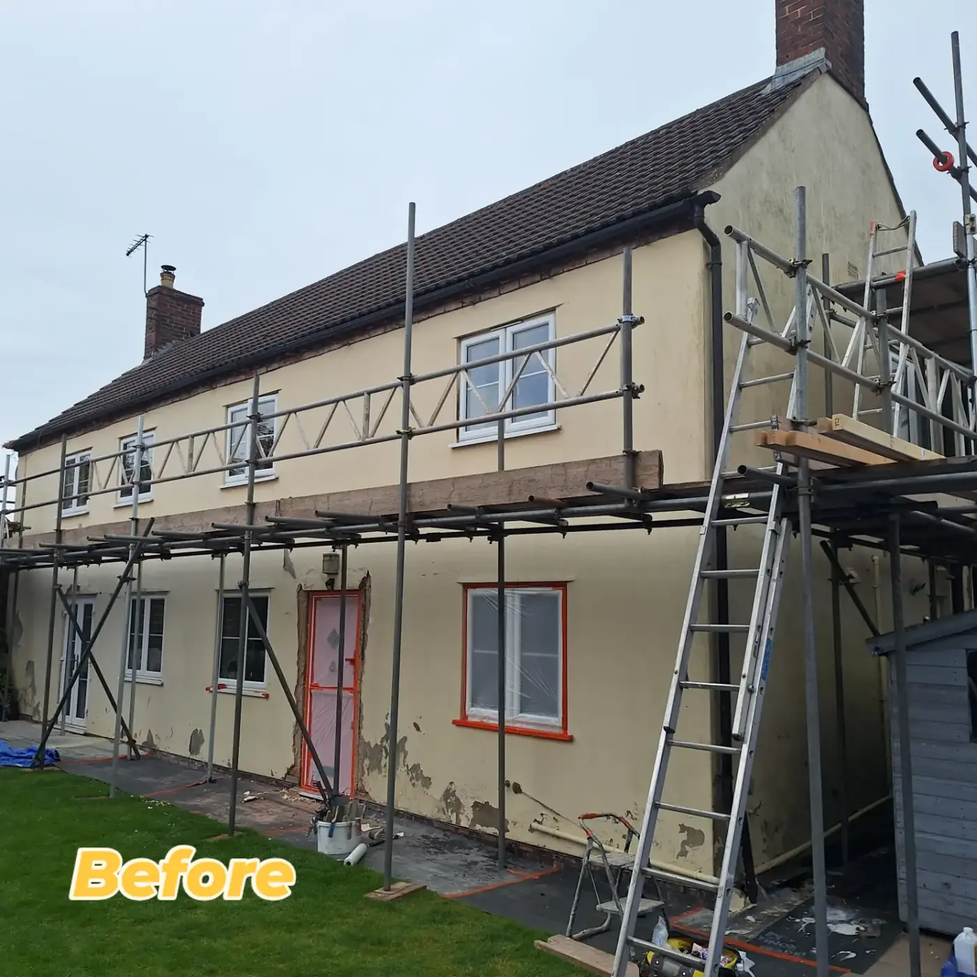 Cottage before: yellowed, patched and blown render on the front elevation
